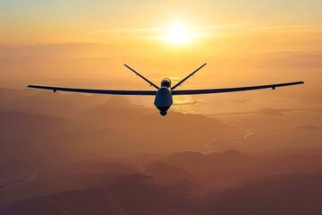 Military unmanned attack drone in the air against the background of the sunset.
