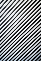 Black and white striped wall with a clock, suitable for interior design projects