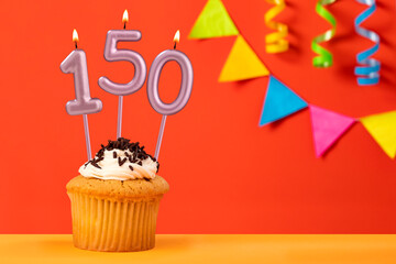 Birthday cupcake with number 150 candle - Sparkling orange background with bunting