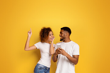 Couple dancing and pointing up while smiling