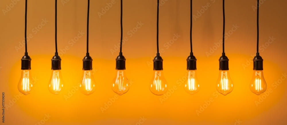 Poster multiple hanging light bulbs in a row, illuminating the space with their glow and creating a visuall