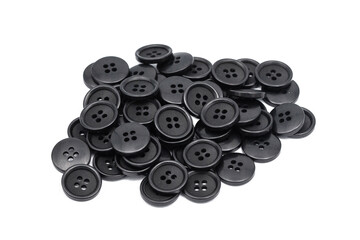 Black clothing buttons isolated on white. Pile of tailor accessories. Cutout circular button. Group...