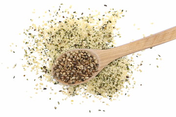 Peeled hemp seed and grain in wooden spoon isolated on white background, top view