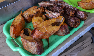 Appetizing pieces of cold smoked fish from local craft producers at the grocery market 