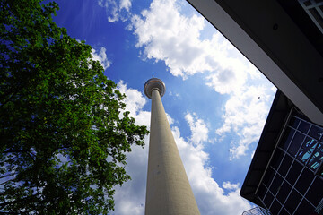 Television tower against the blue sky with clouds in Berlin, Germany - obrazy, fototapety, plakaty