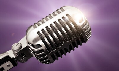 Fototapeta na wymiar Professional classic steel microphone in bright stage lights