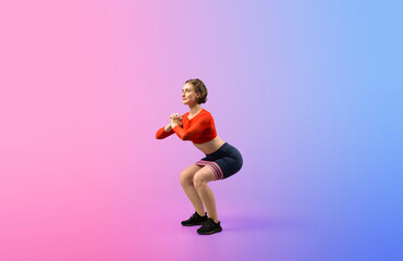 Fototapeta na wymiar Full body length gaiety shot athletic and sporty young woman with fitness elastic resistance band in squat exercise posture on isolated background. Healthy active and body care lifestyle.