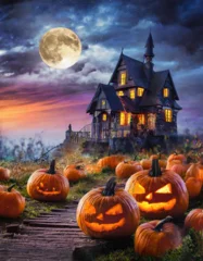 Tuinposter Rotten pumpkins with haunted house and full moon at night. © Bill