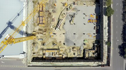 Building, construction and crane or development on drone for real estate, infrastructure or top view. Street, property and location or architecture project or industrial maintenance, labour or site