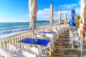 A seaside outdoor cafe along the Plage du Casino, the sandy beach along the Mediterranean Sea at...