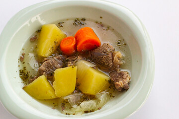 Boiled beef with chopped potatoes, carrots and onions, designed on a plate