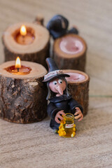Fototapeta premium Halloween witch with candle on wooden background. halloween concept Selective focus.