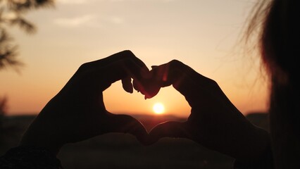 girl heart sign, sunset love symbol, hand silhouette heart, romantic gesture sunset, love hand...