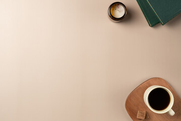 Book, glasses, candle, with cup coffee on beige background. Leisure concept, reading a book. Flat...