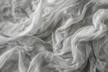 Abstract background of crumpled soft fabric in neutral gray color, close-up top view.