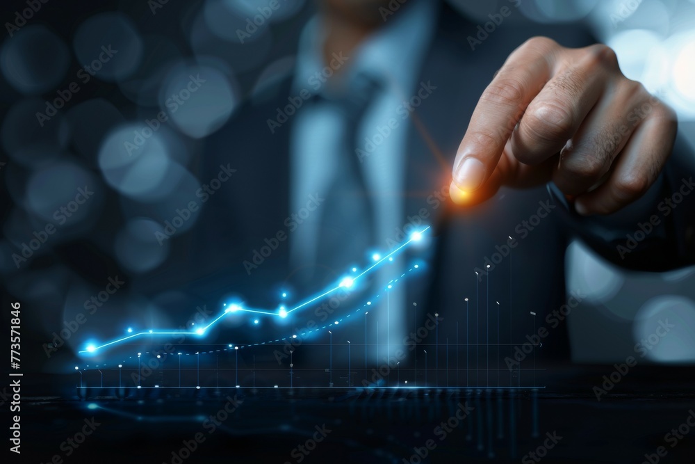 Poster a man in a suit is pointing at a graph on a computer screen