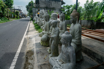 Buddha statues for sale at the side of the road. Ubud, Bali, Indonesia.