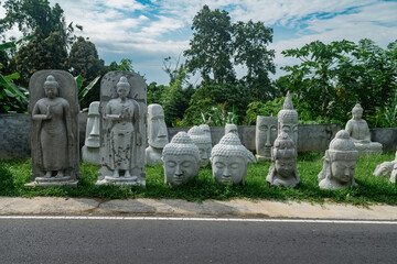 Buddha statues for sale at the side of the road. Ubud, Bali, Indonesia.