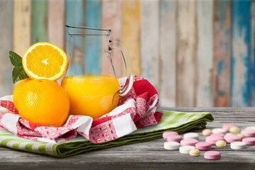 Vitamin C tablets pills and fresh lemons fruit