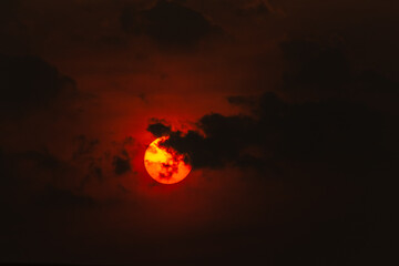 Sunset in the evening sky. Beautiful nature background with sun.
