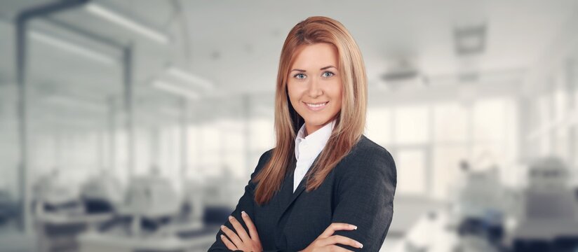 Portrait of female boss at work in modern office