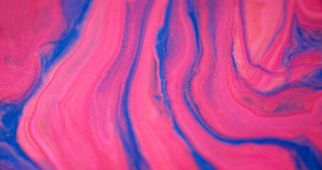 Glitter fluid flow. Paint mix layers. Marble texture. Defocused pink blue color shiny sparkling...