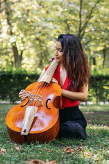 Woman with cello in a park