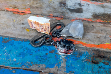 The charcoal cloth is burning from a flint and an ancient fire starter.