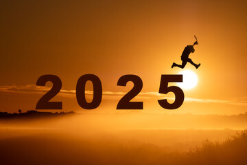 a man jump happy new year 2025 concept, silhouette of a man jumping over the sun in sunrise...