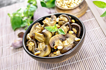 Champignons with oregano and nuts in bowl on napkin