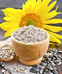 Flour sunflower in bowl with flower on board