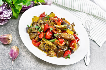 Ragout of eggplant with sweet peppers on stone table
