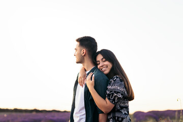 A romantic photograph of a couple in a lavender field