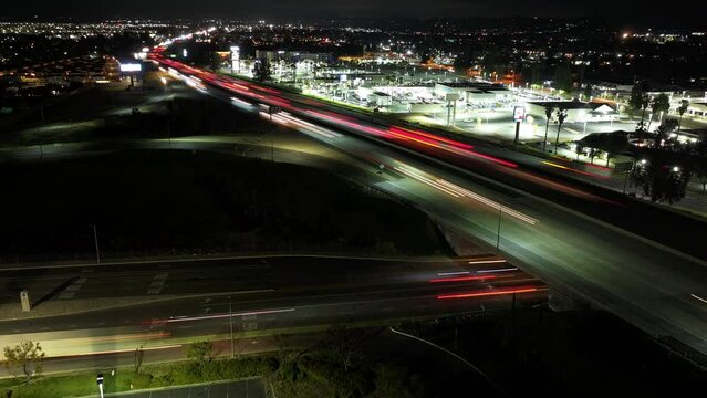 timelapse of Redlands freeway California Highway 10 at night with traffic AERIAL DOLLY BACK