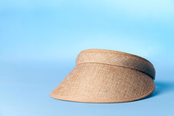 Visor on blue background. Beach concept. Vacation concept. Copy space.