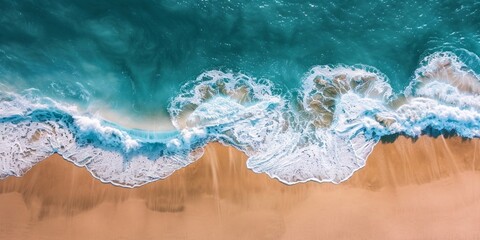 Fototapeta premium A tranquil aerial view of gentle waves washing onto a sandy beach with the ocean in the background