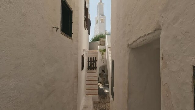 Walk on narrow street of fishermen traditional village Binibequer Vell, Menorca