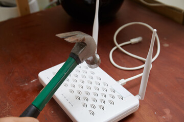 Photo of female hand using hammer to fix the internet at home