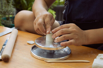 Female potter rolling clay slab
