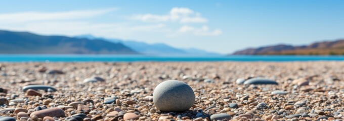 A solitary pebble on a sandy beach, Course on the beach, majestic view on shore - obrazy, fototapety, plakaty