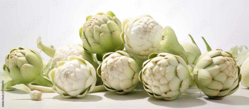 Poster numerous artichokes of various sizes are placed on a wooden table, creating a rustic display in a fa