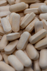 Top view of yellow pills, vitamins, antibiotics, medicines, pharmaceutical concept, background. Selective focus