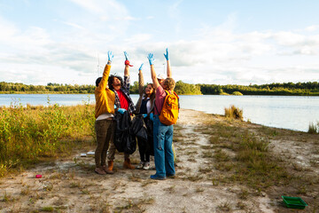 A spirited volunteer group celebrates their contribution to nature by cleaning up a lake's shore....