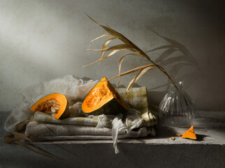 Modern still life with pumpkin on a gray background