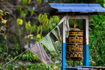 Buddhist religious prayer wheels with Buddhist mantra written in Tibatian language asking for...