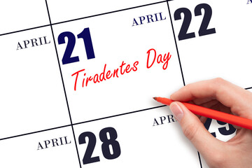 April 21. Hand writing text Tiradentes Day on calendar date. Save the date.