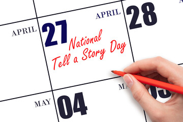 April 27.  Hand writing text National Tell a Story Day on calendar date. Save the date.