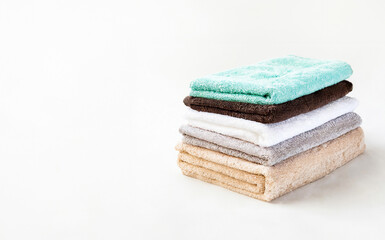 An Immaculate Display of Neatly Stacked White Towels on a Background, Isolated from Surrounding