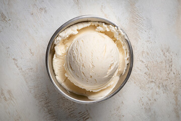 Bowl of banana ice cream and banana on dark background