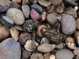 abstract Textured background with round pebble stones. Vacation holiday recreation on beach concept. High quality photo. Fragment with a texture of rock.